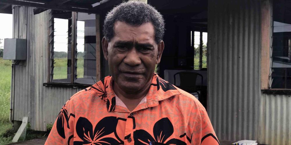 Lepani Kuruduadua, 60, standing outside Naqarani Seventh-day Adventist Church in Naqarani, Fiji. He injured his leg while repairing the church, leading to the amputation. (Andrew McChesney / Adventist Mission)