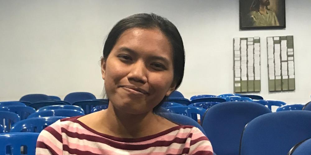 The villagers roasted and boiled a young chicken with black feathers and black feet and offered it to Desi Natalia Ango, pictured. (Andrew McChesney / Adventist Mission)