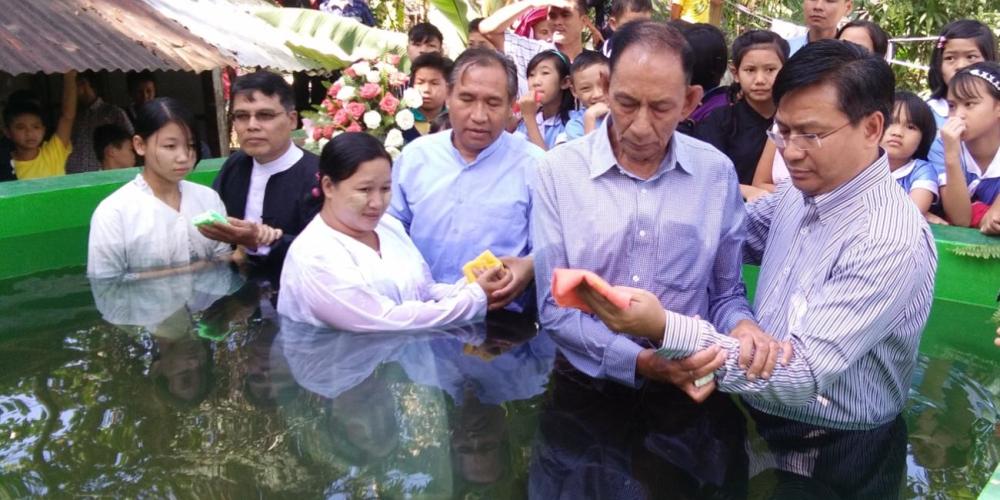 Samuel Saw, right, president of the Southern Asia-Pacific Division, baptizing his father. “I was privileged to baptized my own father at the age of 76,” Samuel says. (Family photo)
