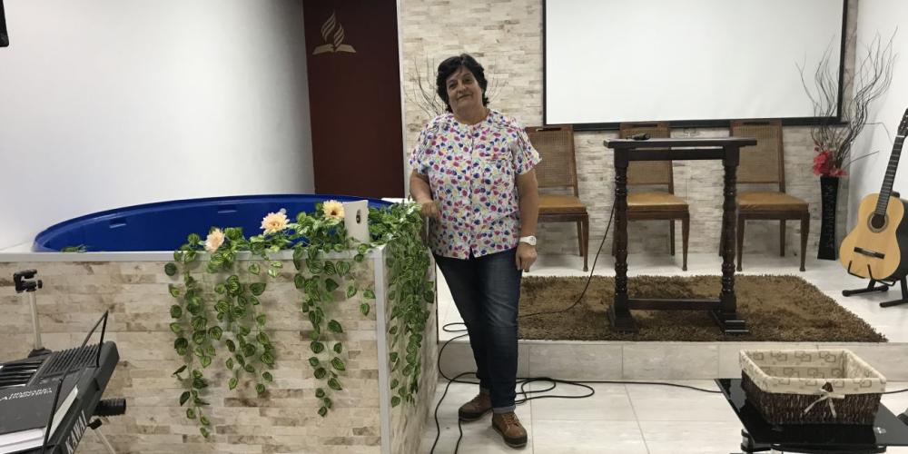Maria Cecilia Freire, 60, standing beside the baptismal pool where she was baptized at Goes Seventh-day Adventist Church in Montevideo, Uruguay. (Andrew McChesney / Adventist Mission)